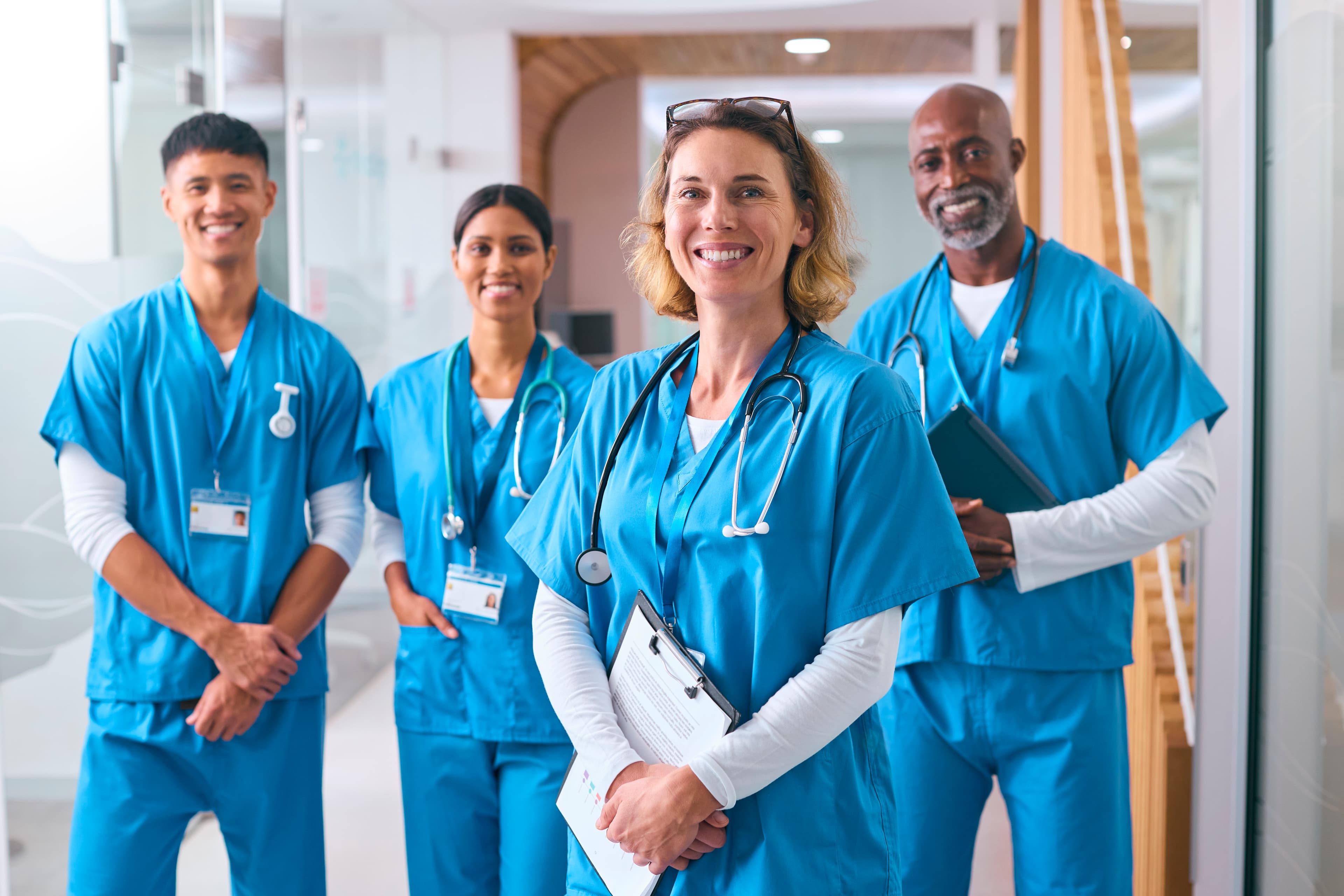 What Sets Us Apart Multicultural medical team smiling together in a clinical setting