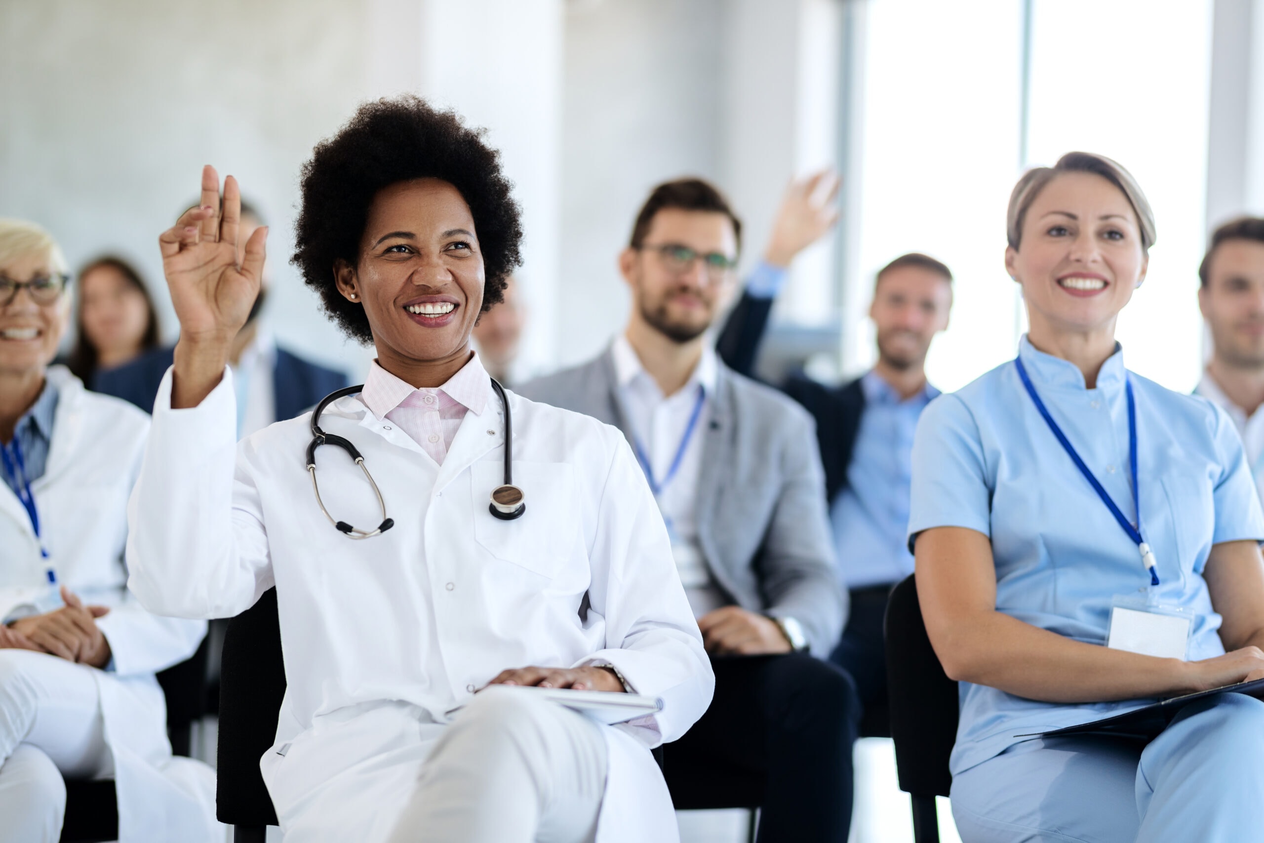 Nursing Leadership & Informatics Certification Prep Nurse raising her hand during a nursing leadership and informatics certification training session