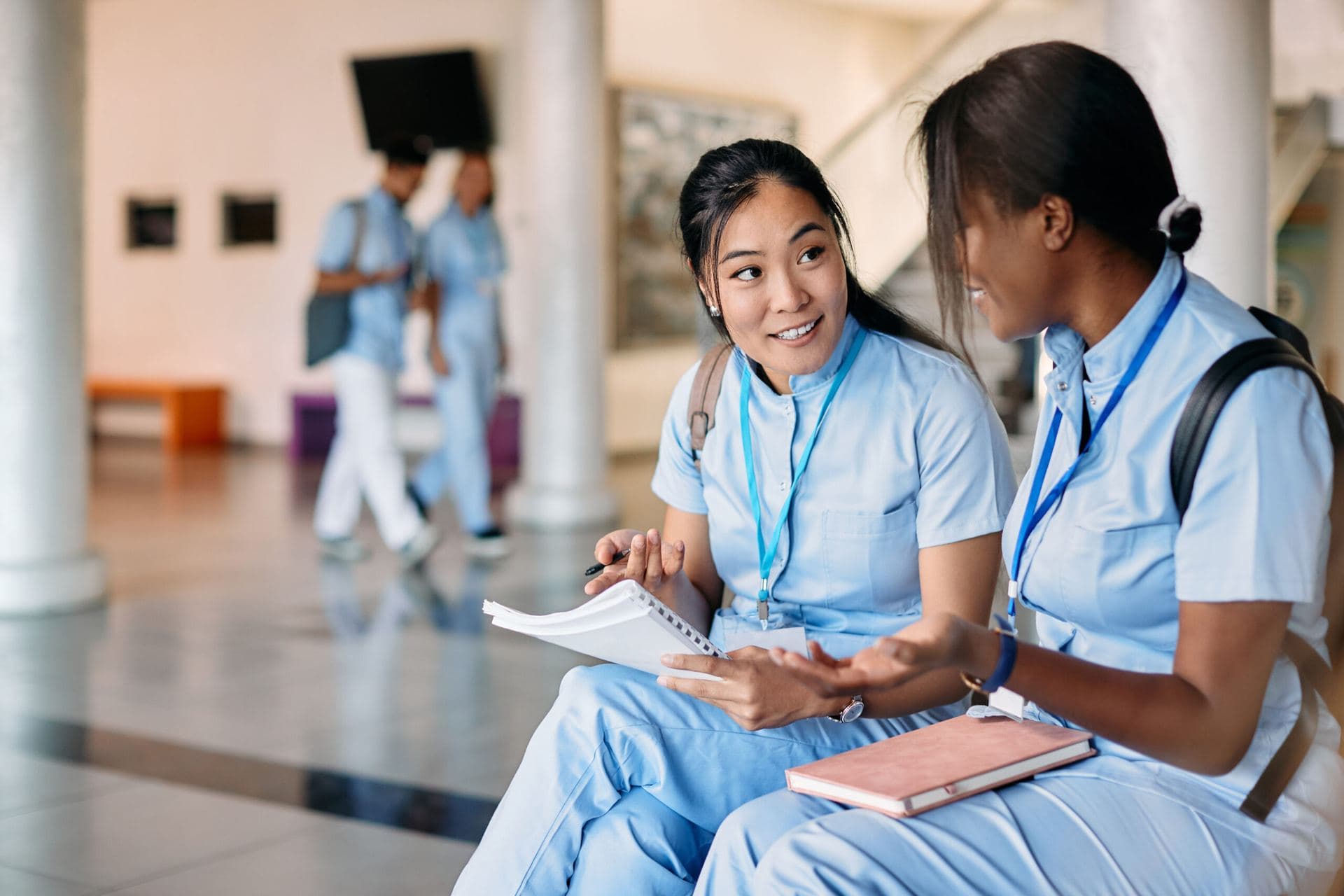 Why Our Question Banks Work Nursing students reviewing certification study materials together